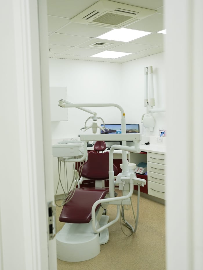 A dental surgery with treatment chair and monitor at Luna Dental, Cardiff